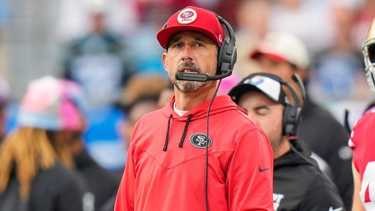 49ers coach Kyle Shanahan shows off his throwing arm to Joe Staley ...